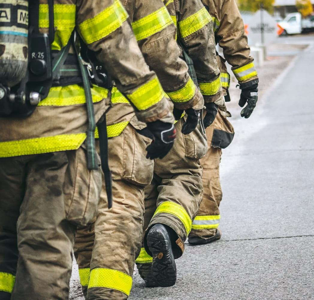Firefighters walk in a line